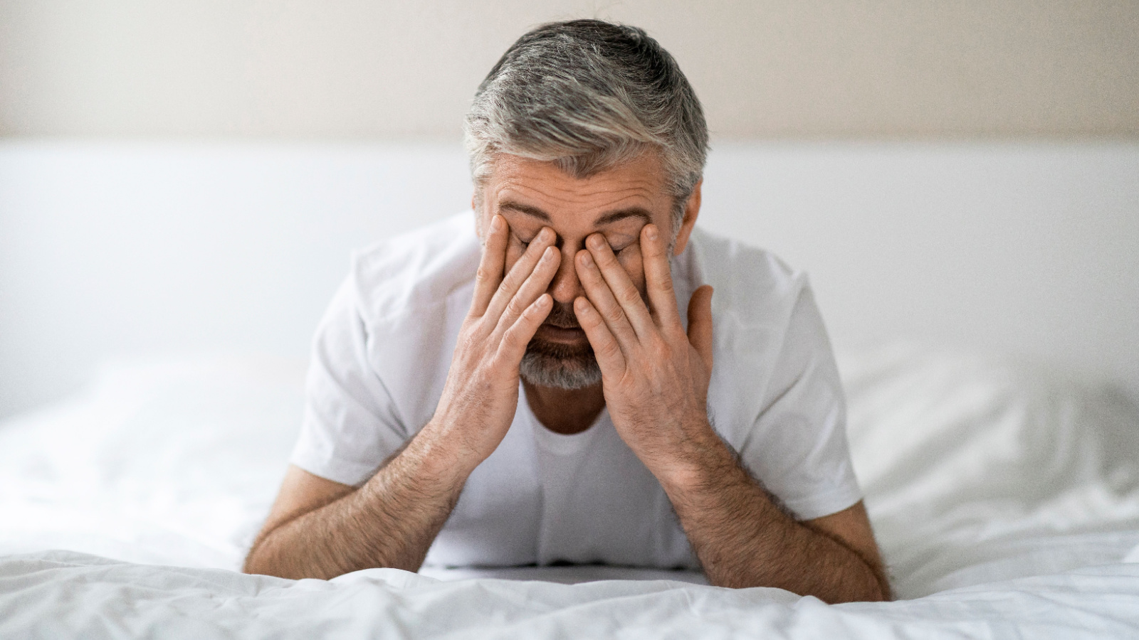 male sleeping disorder tired exhausted in bed